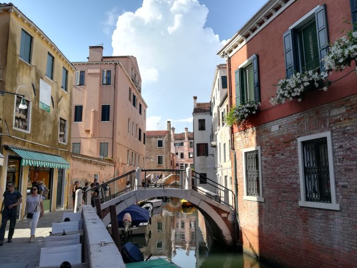 venice-real-photo A canal, stone bridge and colourful buildings in Dorsoduro, Venice